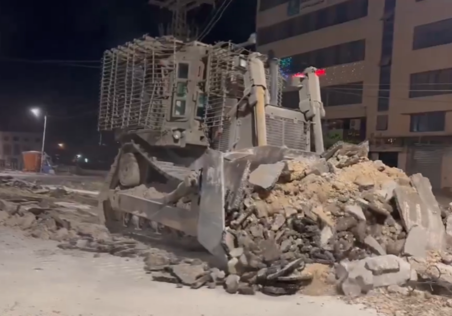 An IDF bulldozer checks for explosive charges beneath roads approaching the Nur Shams camp near Tulkarem (Screenshot)